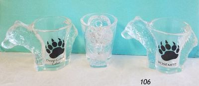 Bear shaped clear shotglass with one side souvenir design. 