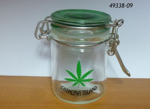 49338-09 Miniature stash jar shot with green lid and pot leaf design.  Catalina Island. 