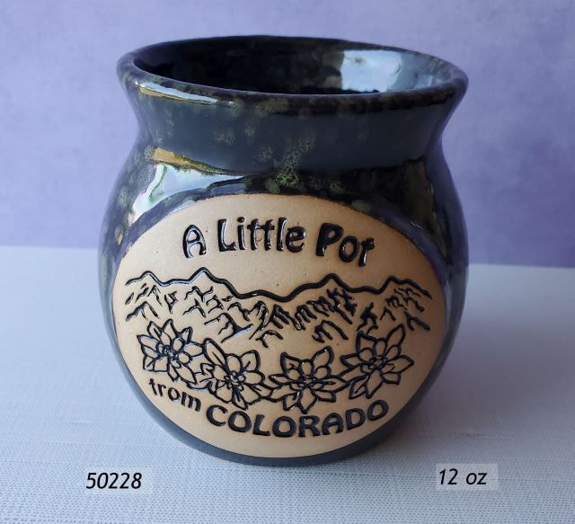50228 Colorado Souvenir Ceramic Pot with green and black mottled glaze and a unfinished oval field with debossed A Little Pot From Colorado imprint with columbine flowers and mountain range.  Larger size, holds 12 oz. 