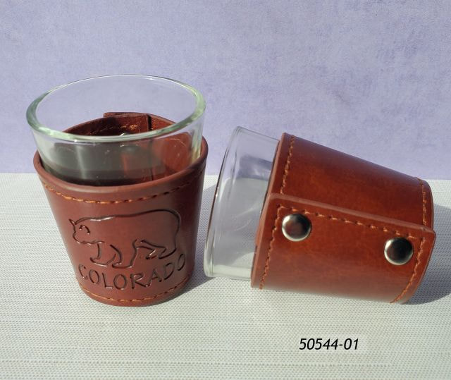 50544-01 Colorado souvenir shotglass with brown leatherette snap casing.  Leatherette is debossed with a bear outline and the word Colorado. 