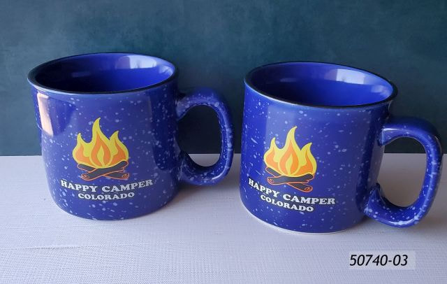 50740-03 Heavyweight Colorado Souvenir Mug with Blue color and white speckles throughout.  Decal design on one side of a campfire and it reads Happy Camper Colorado. 