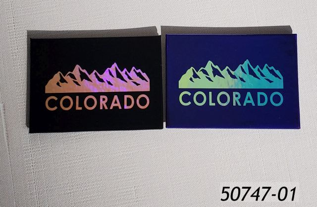 50747-01 2 Assorted Colorado souvenir magnets, 2.5" x3.5" with iridescent mountain design.  Magnets come assorted black and blue colors