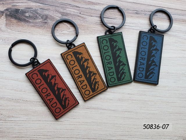 50836-07 Colorado Souvenir keyring in 4 assorted leatherette colors with matte black  hardware.  Design is a mountain range. 