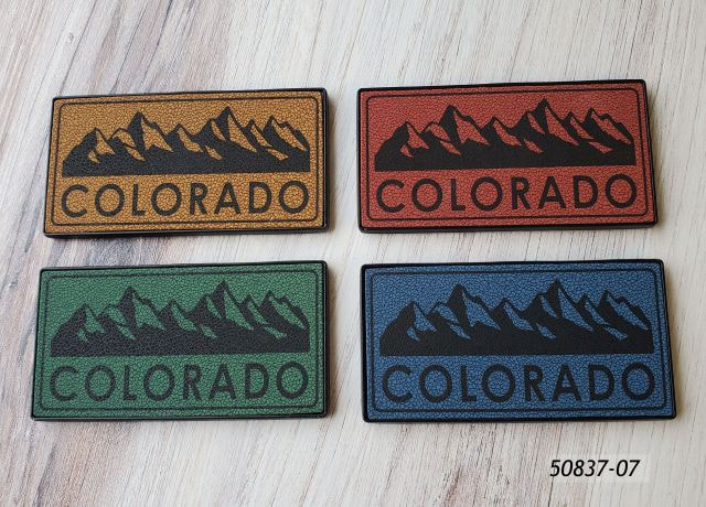 50837-07 Colorado souvenir magnets.  4 assorted colors with mountain range design.  Rectangular shape. 